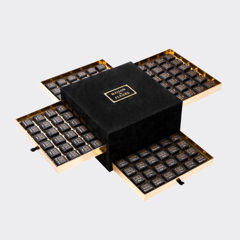 144 of assorted chocolate pieces hidden in 4 golden drawers inside a grandiose velvet box.