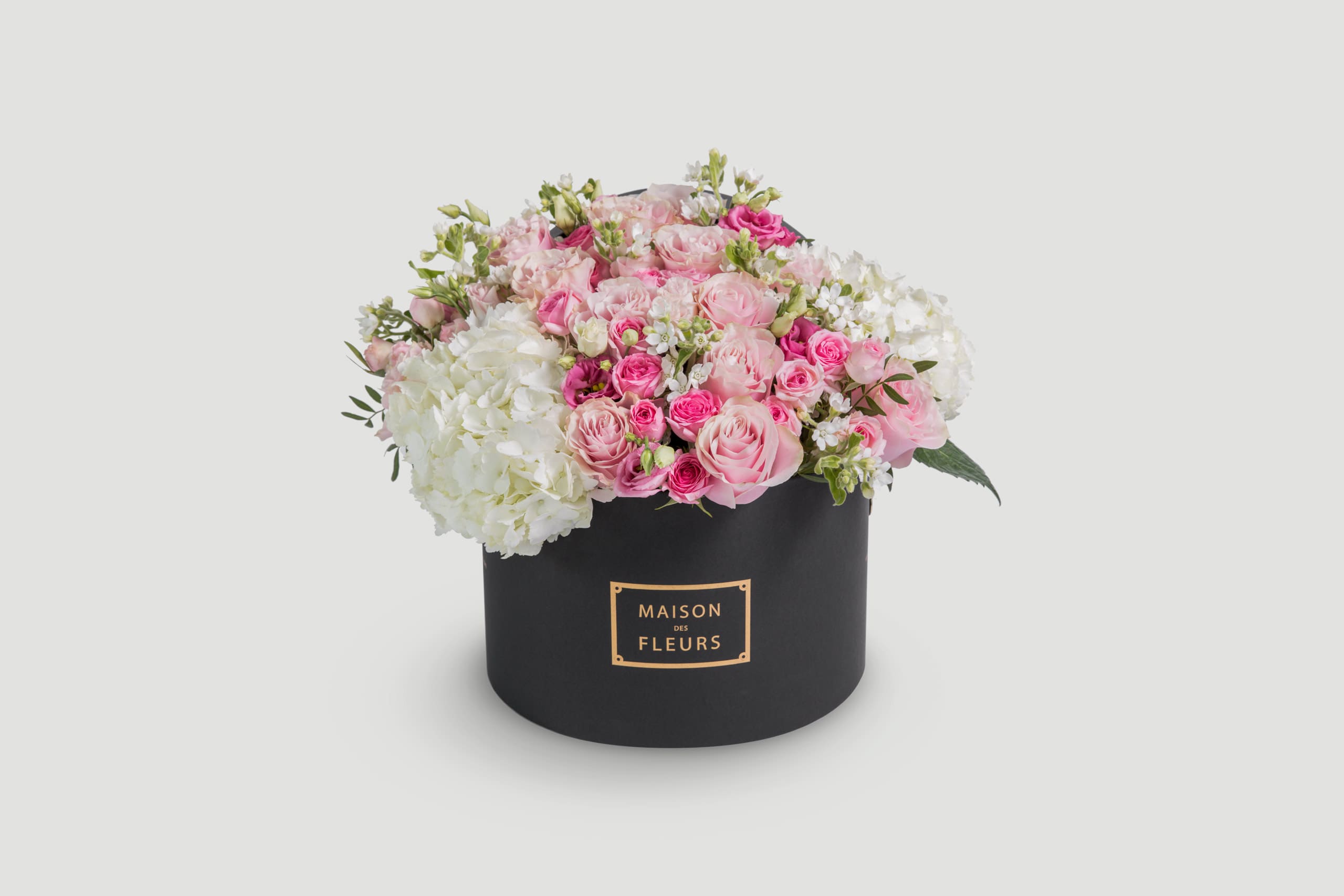 Pink and White Roses arranged in a round black box