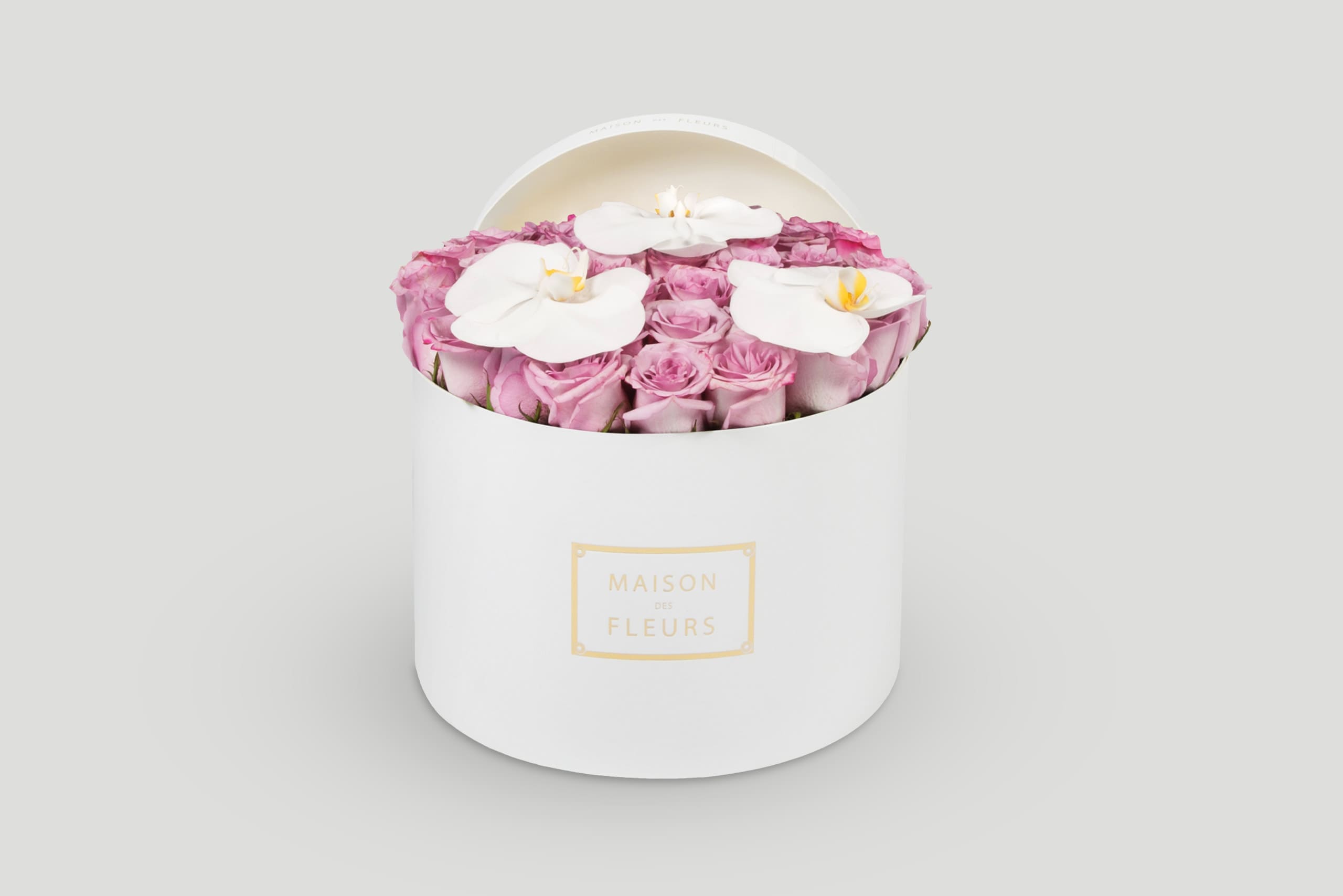 White Round Hatbox Filled With Light Pink Roses and Topped With Three White Orchids