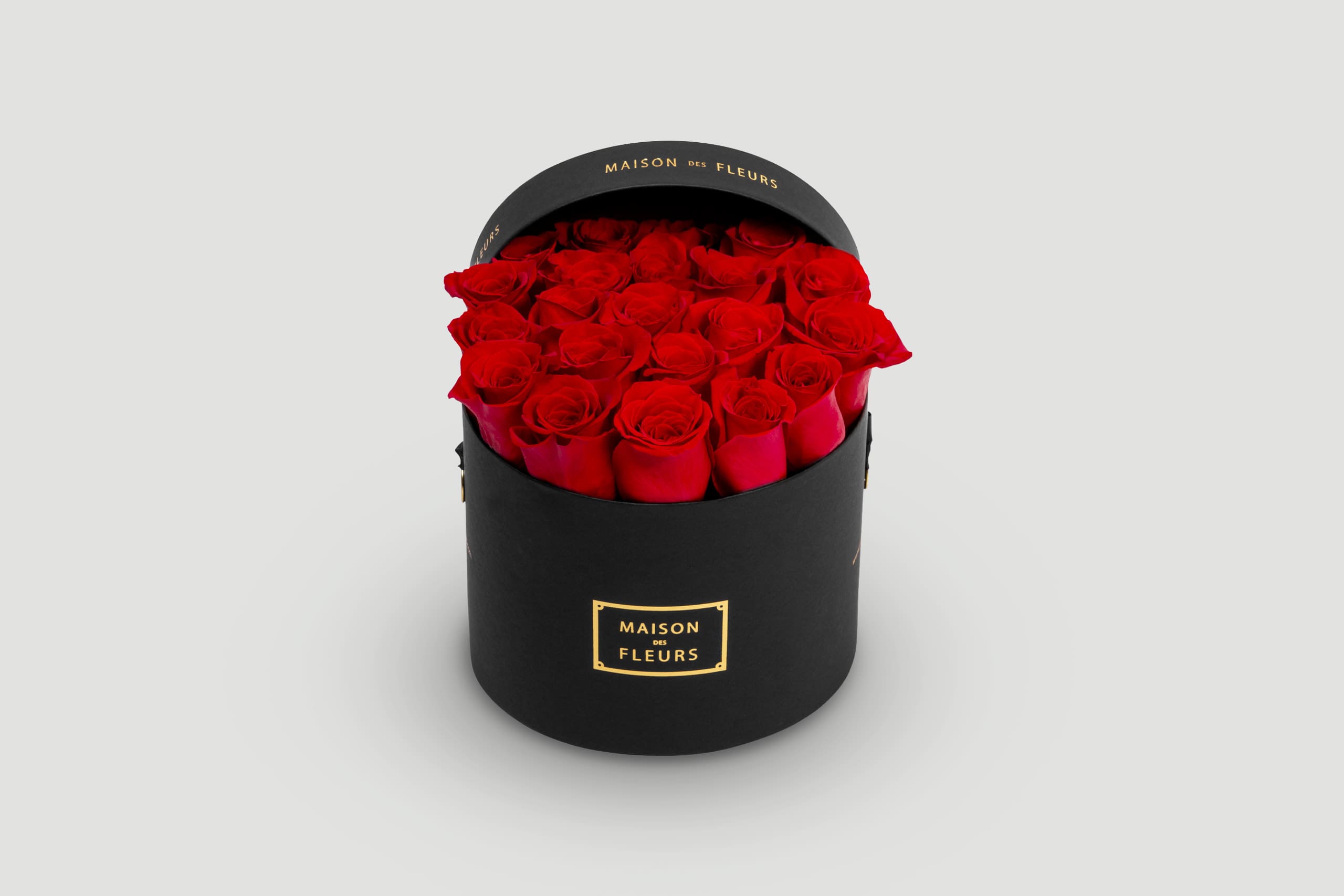 Red Roses Arranged in a Black Box with a Gold Label