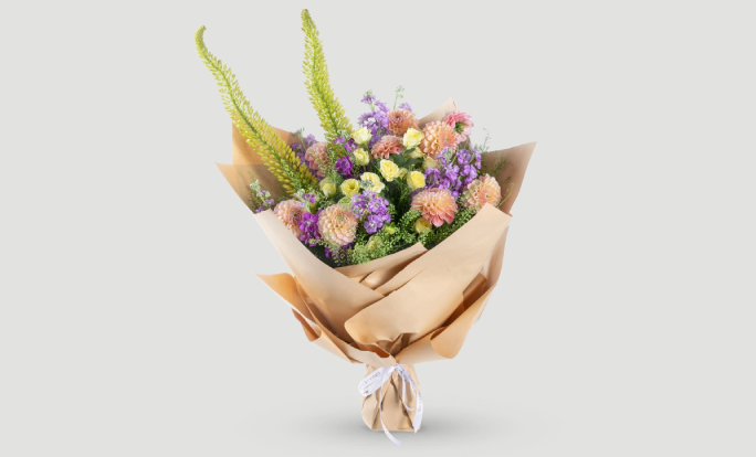 bouquet of mixed flowers wrapped in brown paper